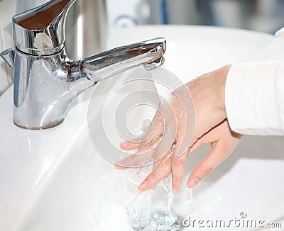 thorough washing of the girl s hands in the sink with running wa Stock Photo