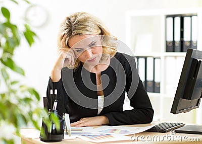 Thoughful middle aged businesswoman working on Stock Photo