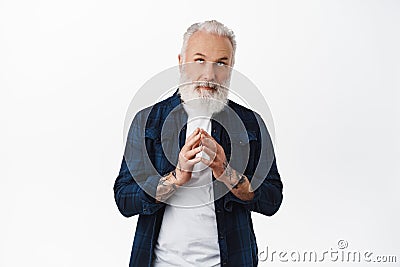 Thoughful old stylish man steeple fingers, looking up and thinking, making plan, scheming like evil genius while reading Stock Photo