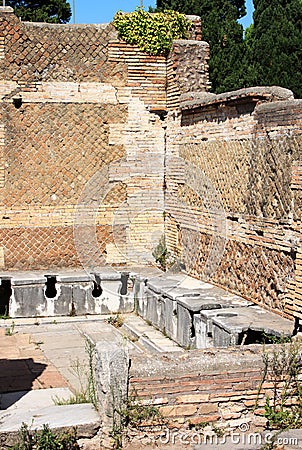 Ancient Roman latrines at Ostia Antica, Italy Stock Photo
