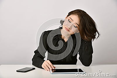 Thoughtful asian woman working with tablet computer in office. Stock Photo