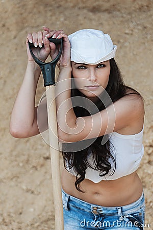 Thoughtful beautiful leaning shovel Stock Photo