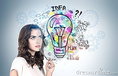 Pensive young woman with pencil, business idea Stock Photo