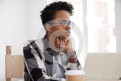 Thoughtful black female look in distance making decision Stock Photo