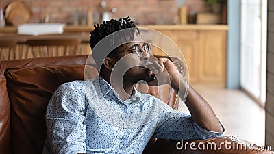 Thoughtful bored millennial Black mixed race guy lost in thoughts Stock Photo