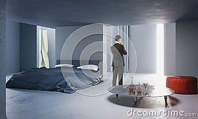 Thoughtful businessman in concrete bedroom Stock Photo