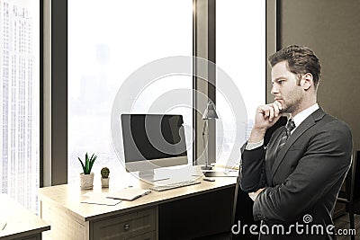 Thoughtful businessman in office Stock Photo