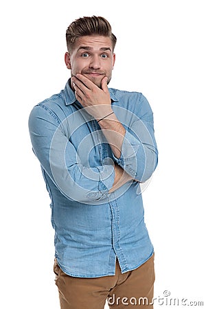 Thoughtful casual man making a funny face Stock Photo