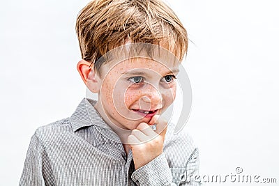 Thoughtful cheeky kid scratching his chin to imagine or conspire Stock Photo