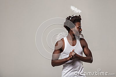 Thoughtful confused man. dark skinned angel with nimbus and wink Stock Photo