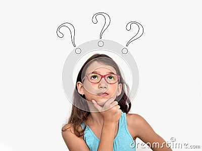 Thoughtful young girl with three question marks Stock Photo