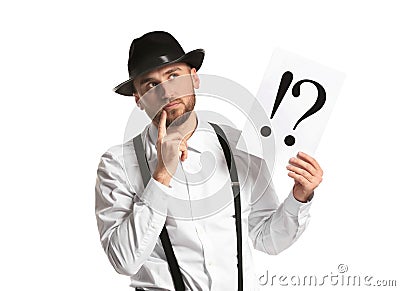 Thoughtful detective holding sheet of paper with exclamation and interrogation marks on white background Stock Photo