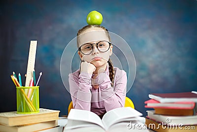 Thoughtful Elementary School Girl Apple on Head Stock Photo
