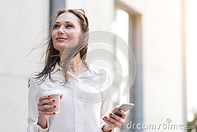 Thoughtful female typing in phone Stock Photo