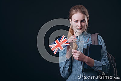 Thoughtful Girl With British Flag Touching Her Lip With Glasses Earpiece Stock Photo