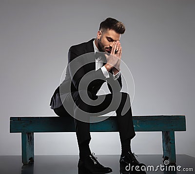 Thoughtful groom praying with his eyes closed Stock Photo