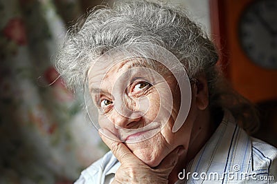 Thoughtful and looking elderly woman face Stock Photo