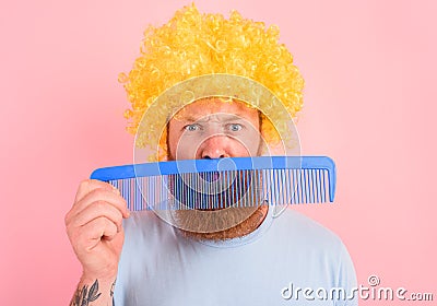 Thoughtful man with beard, yellow peruke and big comb Stock Photo