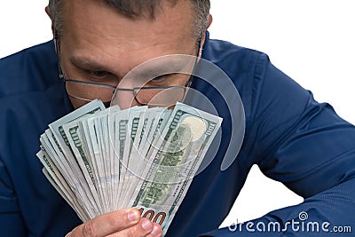 Thoughtful man holding a fanned handful of money Stock Photo