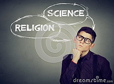 Thoughtful man making up his mind science or religion Stock Photo