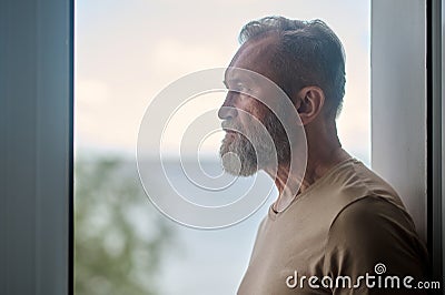 Thoughtful mature man looking into the distance Stock Photo