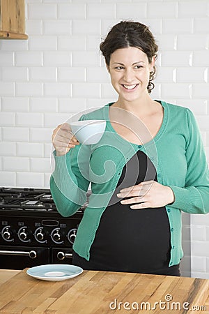 Thoughtful Pregnant Woman Drinking Tea Stock Photo