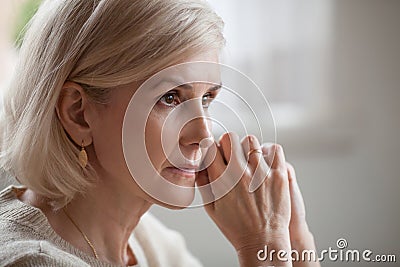 Thoughtful serious anxious mature senior woman feeling worried a Stock Photo