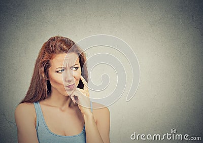 Thoughtful skeptical suspicious young woman Stock Photo