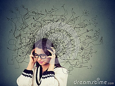 Thoughtful stressed young woman in glasses with a mess in her head Stock Photo