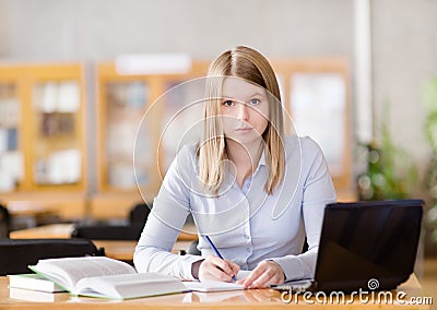 Thoughtful student in library. Stock Photo