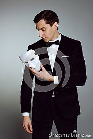 Thoughtful successful handsome young man with mask. Stock Photo