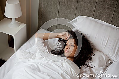 Thoughtful woman in bed Stock Photo