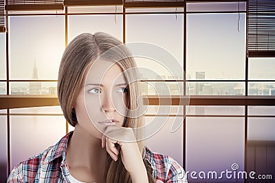 Thoughtful woman in interior with city view Stock Photo
