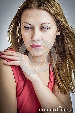 Thoughtful woman in red dress. Stock Photo