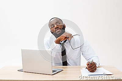 Thoughtful young african american businessman working on laptop computer Stock Photo