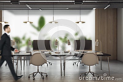 Thoughtful young businessman walking in modern coworking office interior with equipment, furniture, decorative plants and matte Stock Photo