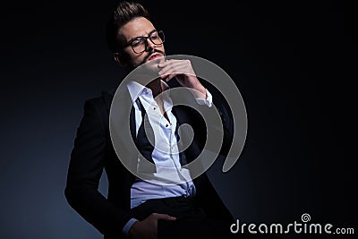 Thoughtful young elegant man in tuxedo with undone bowtie Stock Photo