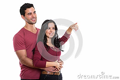 Thoughtful young happy couple smiling while hugging each other w Stock Photo