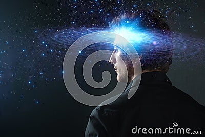 Thoughtful young man, creative mind concept. A man with a galaxy in his head, Stock Photo