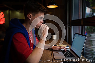 Thoughtful young man skilled freelance writer looking on laptop computer Stock Photo