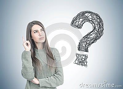 Thoughtful woman pointing up, question mark Stock Photo