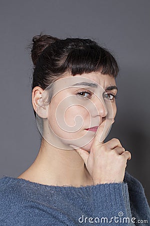 Thoughtful young woman ready to criticize Stock Photo