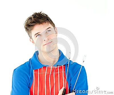 Thougtful young cook holding a cookware Stock Photo