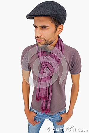 Thougthful man wearing peaked cap and scarf Stock Photo