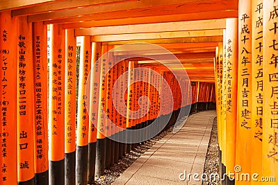 Thousands of Japanese shrines forming a tunnel walk way Stock Photo