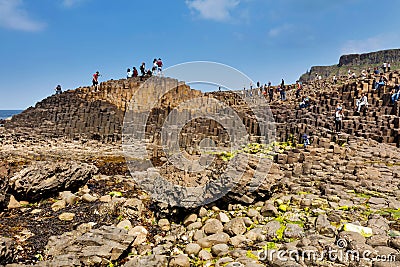 Thousands of tourists visiting Giant`s Causeway in County Antrim of Northern Ireland Editorial Stock Photo