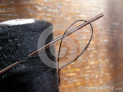 Thread spool and needle Stock Photo