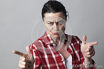 Threatening middle aged woman provoking with aggressive hand gestures Stock Photo