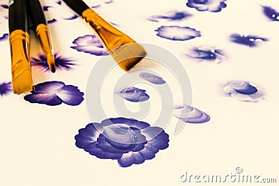 Three acrylic paint flat brushes. Basic one stroke painting, painting stroke explained for beginners. Hand drawn folk blue flowers Stock Photo