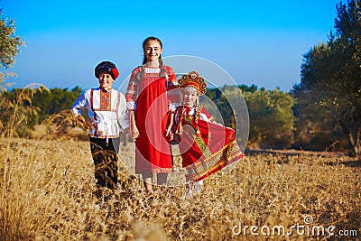 Three adorable kids in folk Russian costume and headdresses Stock Photo